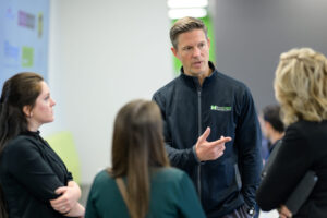 Bradley McCloskey speaks with healthcare providers during MediVera’s grand opening event in Troy.