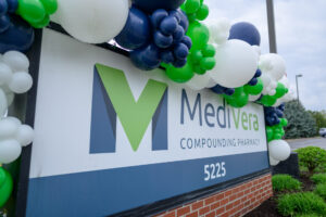MediVera Compounding Pharmacy sign decorated with branded balloons at the Troy facility grand opening.