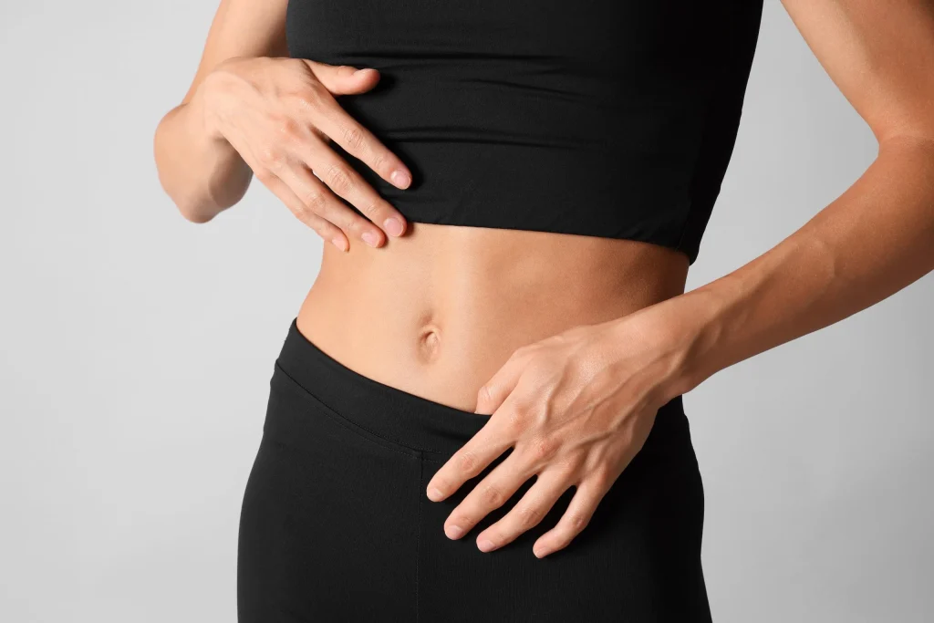 Woman's midsection in activewear, representing compounded weight management treatments