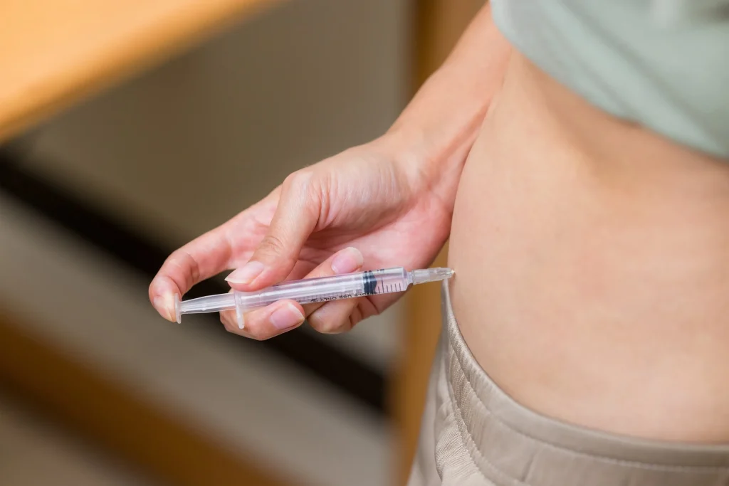 Close-up of a subcutaneous injection being administered, representing compounded peptide therapy