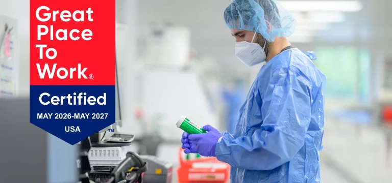 MediVera Compounding Pharmacy team member working in a compounding lab alongside the Great Place To Work Certified badge, May 2026–May 2027, USA