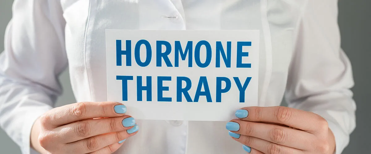 A person holding a sign reading "HORMONE THERAPY."
