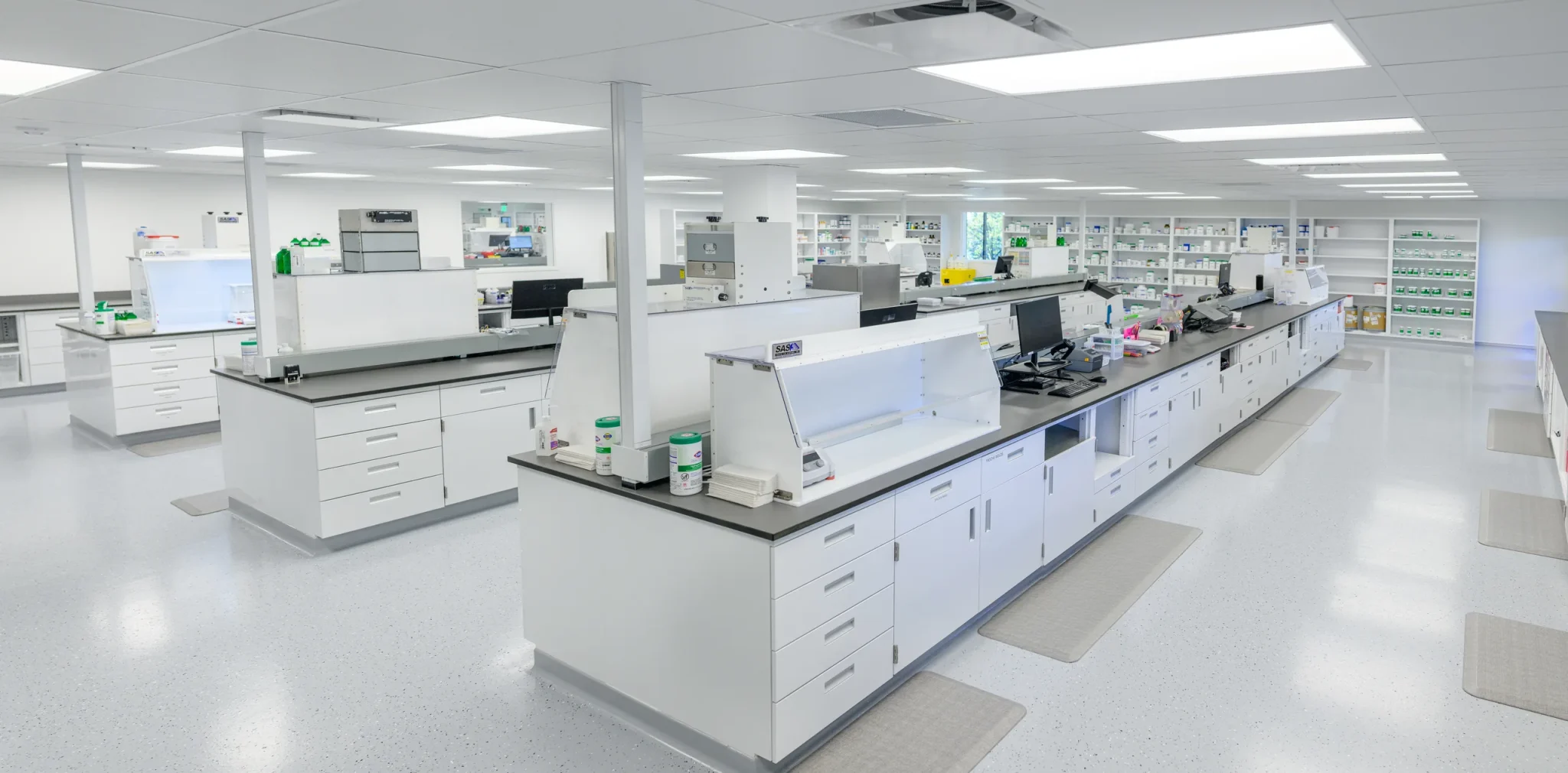 MediVera compounding laboratory interior with rows of white workbenches and dispensing equipment